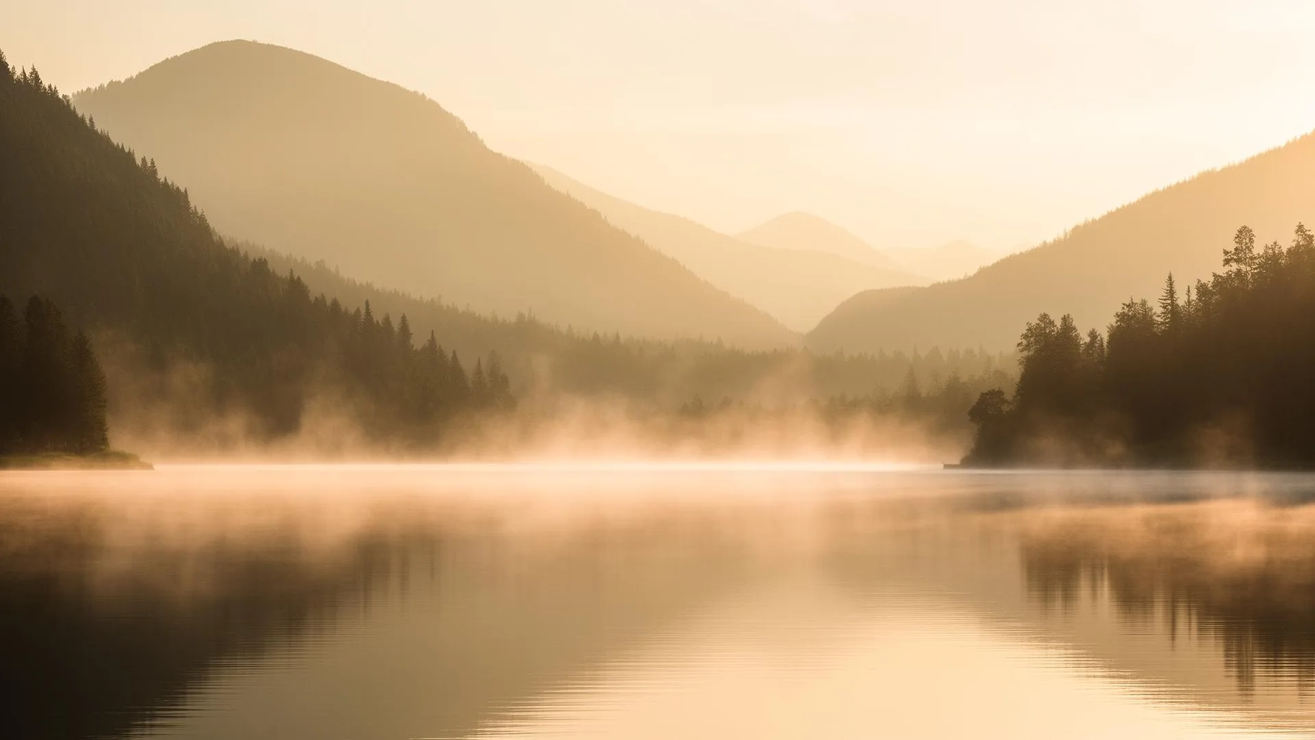Misty mountain lake at sunrise — symbol of a retreat